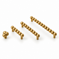 Beaded brass cabinet handles and knob in brushed brass, all sizes side by side