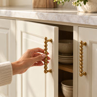 Beaded brass cabinet pulls styled on kitchen and bedroom furniture