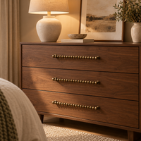 Beaded brass drawer pulls on a dresser