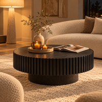 Black round fluted coffee table styled in a living room